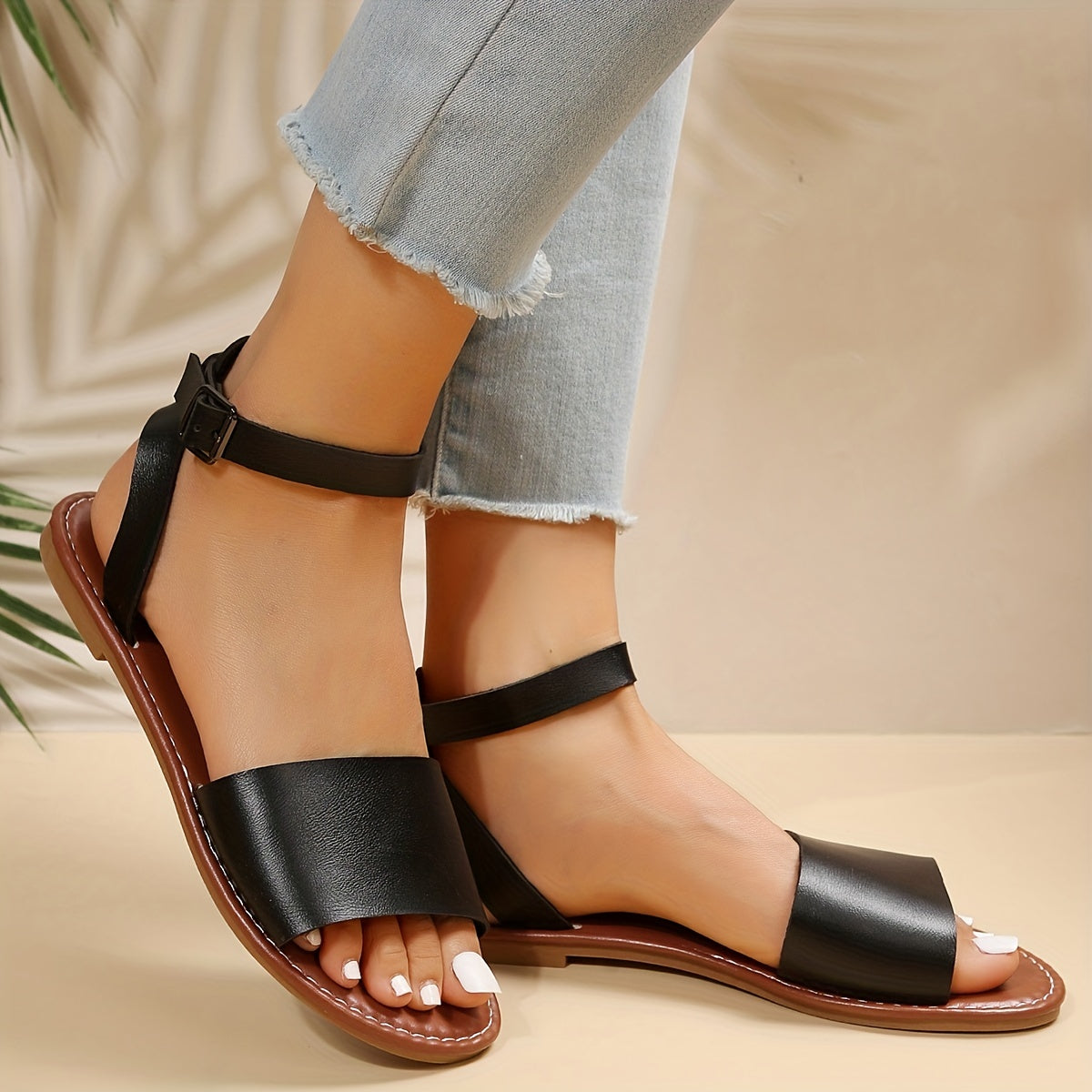 Flat summer sandals for women with solid color, open toe design and ankle strap. Made of lightweight faux leather, suitable for the beach.