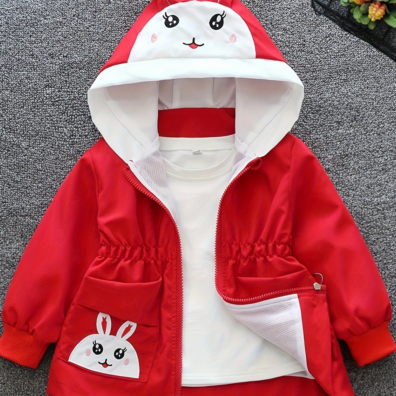 Girls' cute bunny-themed windbreaker in light pink, long sleeve, polyester blend, non-stretch fabric with pockets. Ideal for spring and autumn.