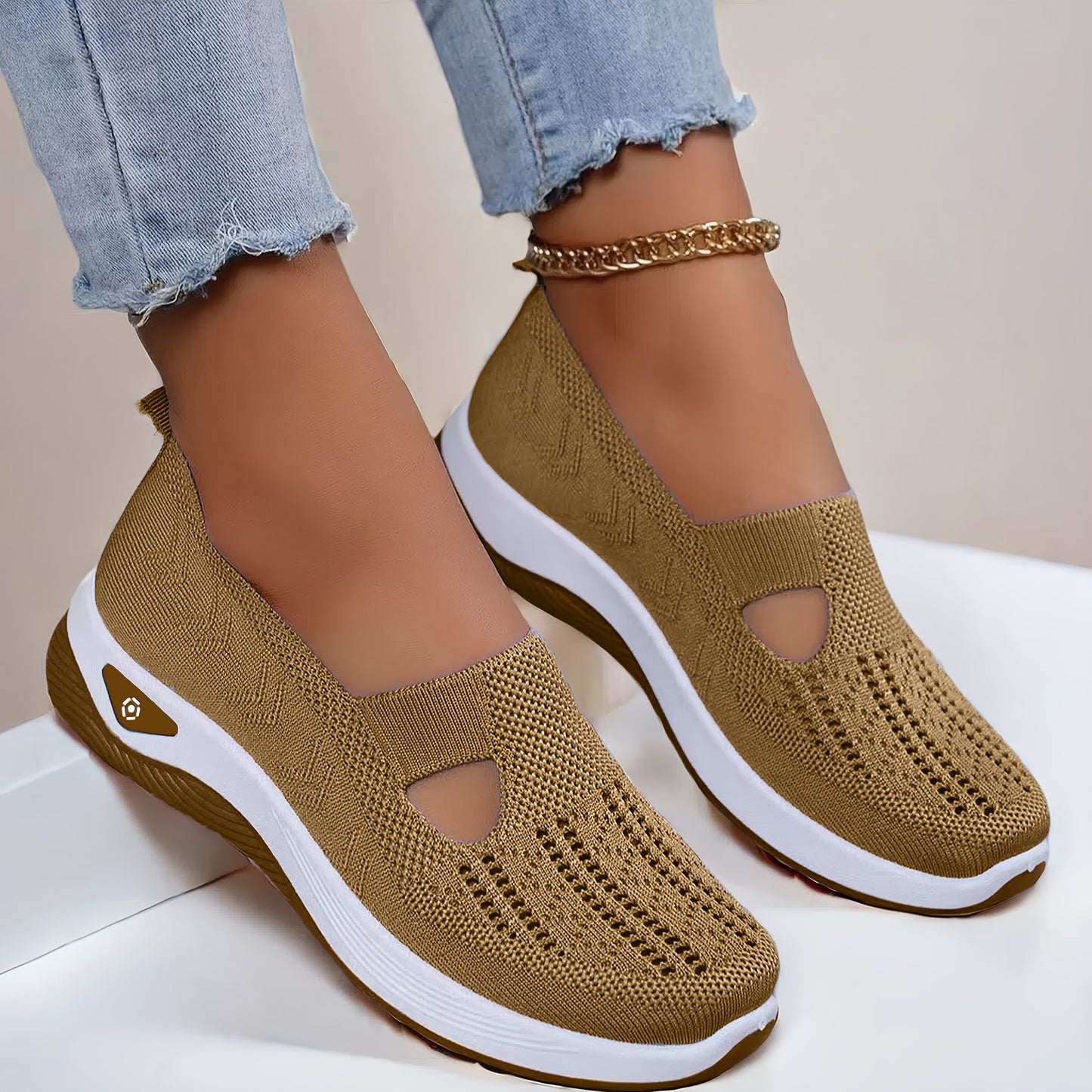 Lightweight and stylish knit sneakers for women in red, beige, green, blue, black, and purple. Features a cut-out design for breathability and a flexible sole for all-season wear.