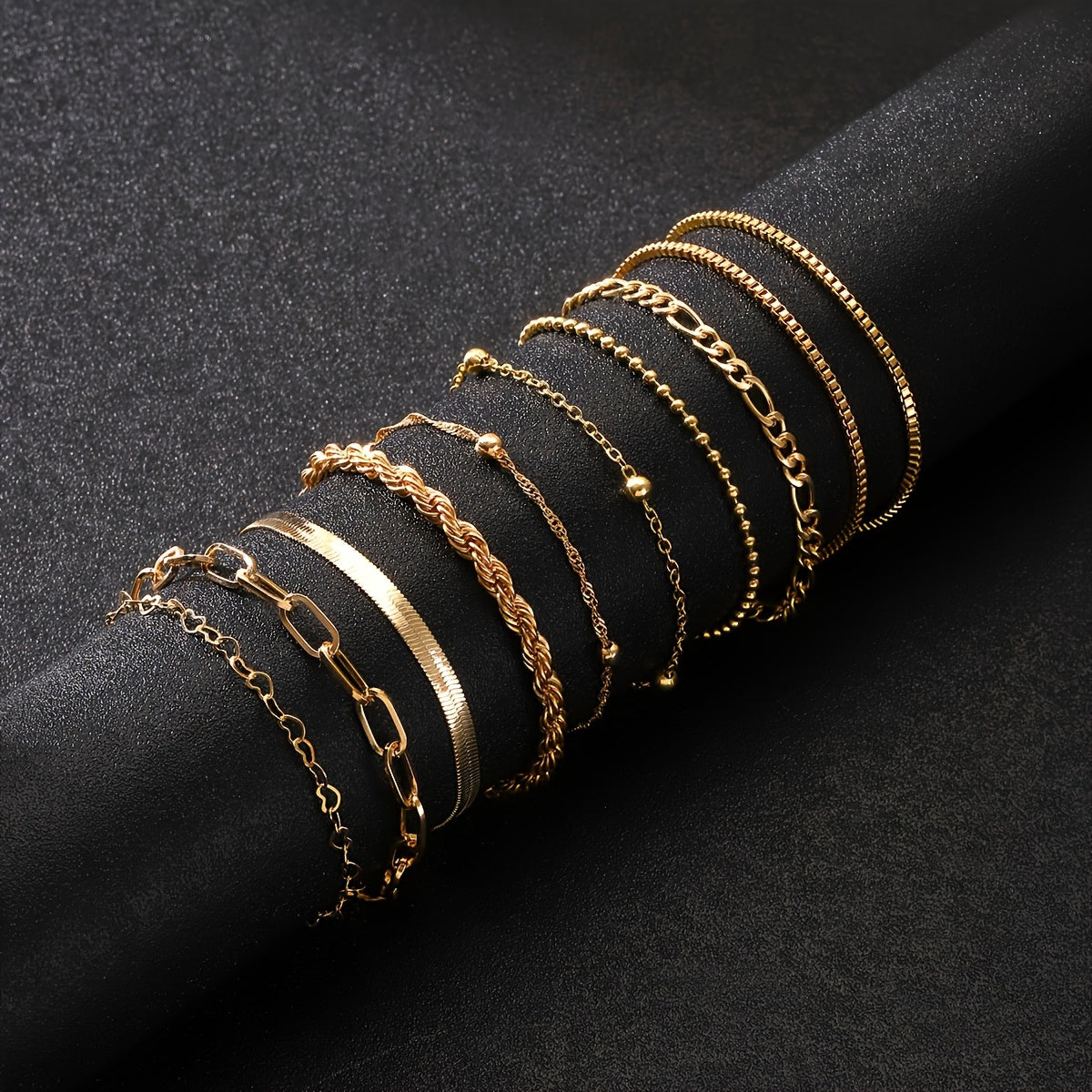 Set of 10 elegant golden-toned bracelets with multi-layer designs and heart charms, ideal for daily wear or parties.