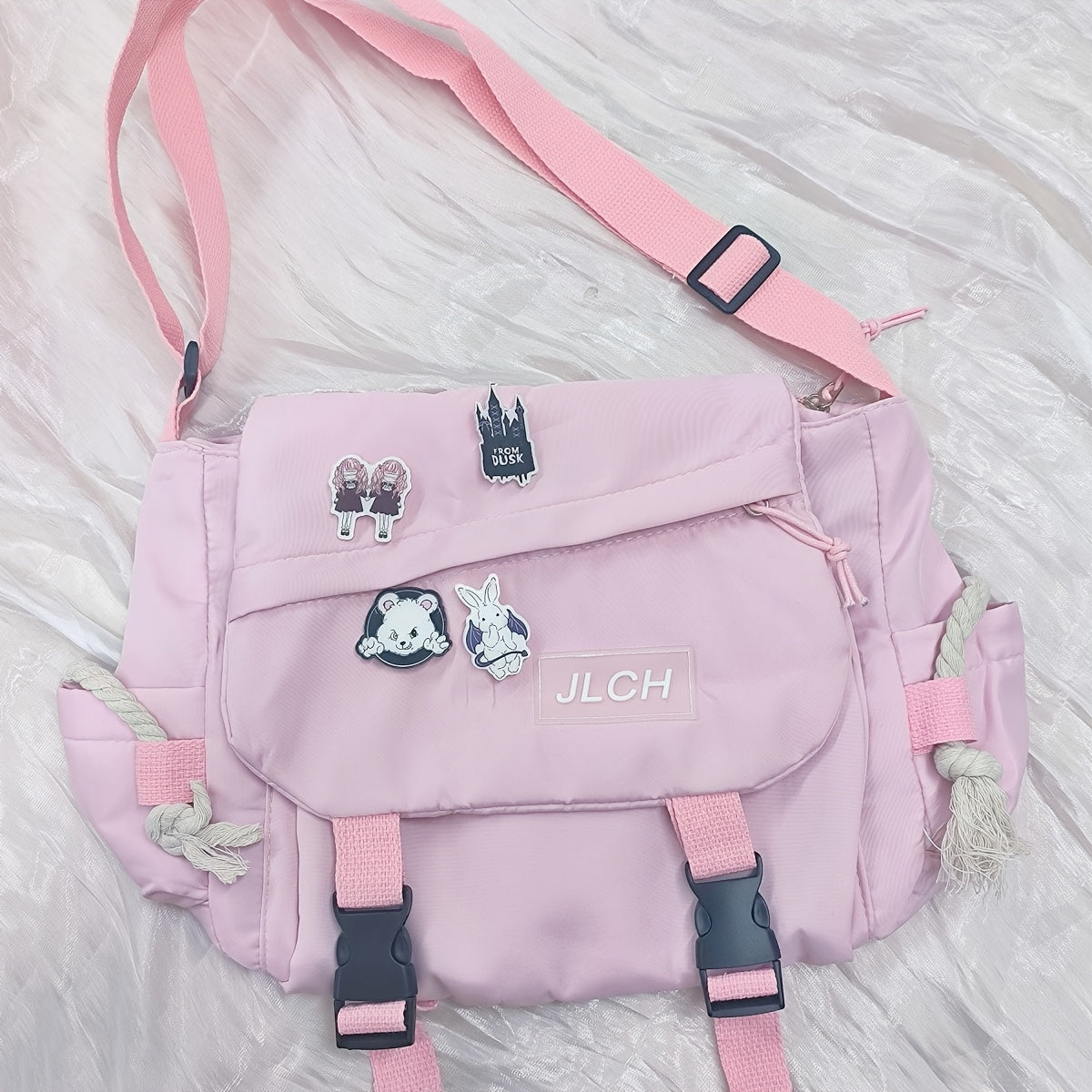 Adjustable unisex shoulder bag in white, pink, blue, or black, suitable for school, travel, and everyday use with a stylish and functional design.