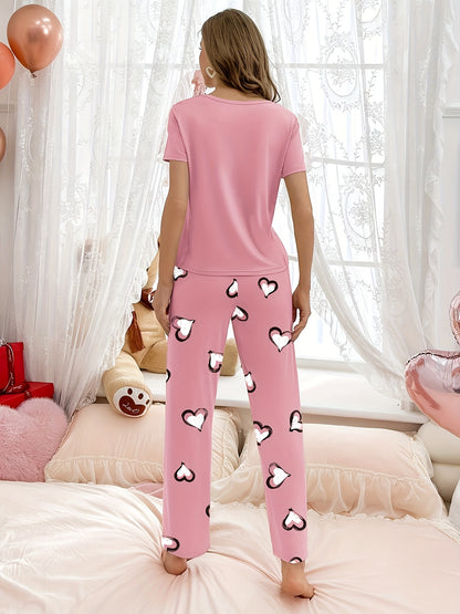 Stylish pink heart print pajama set for women with comfy short sleeve top and long pants, made of breathable polyester blend fabric.