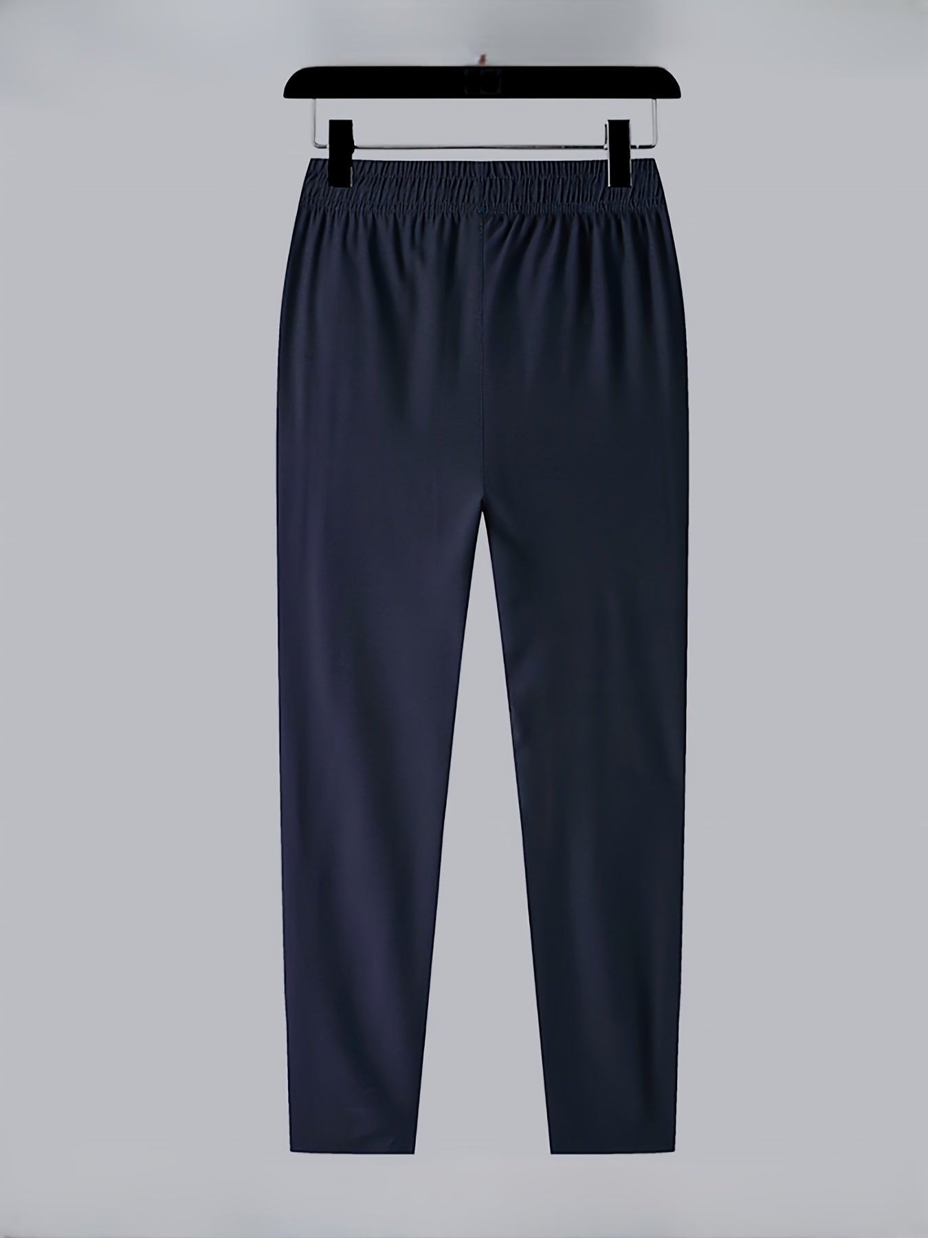 Three-pack of men's plus size track pants made of 100% polyester with a slight stretch, regular fit, woven fabric, print pattern, and zipper detail.