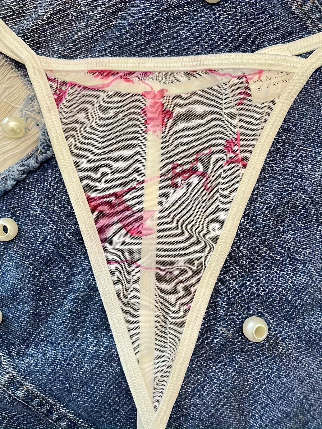 Floral print sheer thong panties made of breathable polyester and elastane blend, mid-rise and hand washable.