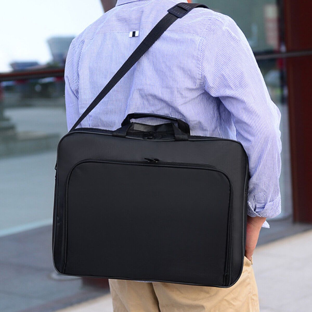 Durable black laptop sleeve with shoulder strap and compartments.