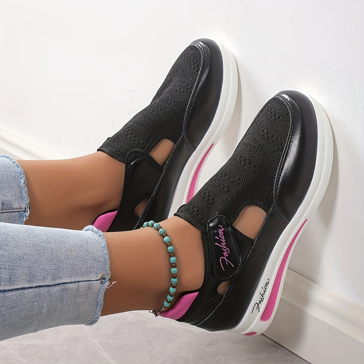 Breathable mesh women's sneakers with slip-on platform design, ideal for sports and tennis. Black with white and pink accents, low-top silhouette with comfortable fabric interior. Versatile