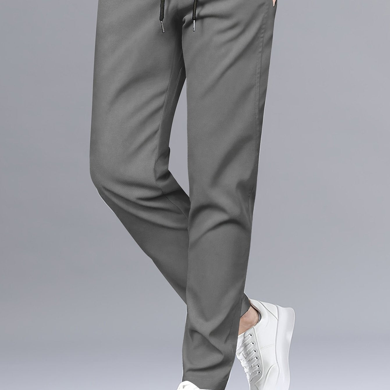 Stylish men's solid pants with pockets, casual and breathable drawstring trousers for outdoor activities.