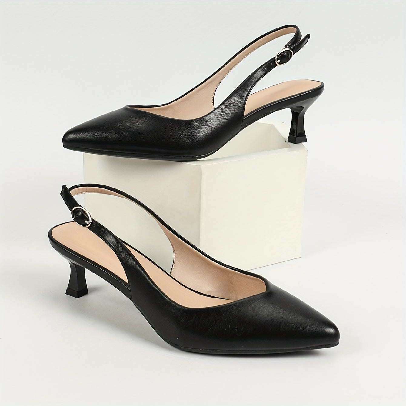 Stylish women's slingback shoes with pointed toe, mid-heel, solid color, and faux leather cover on rubber sole.