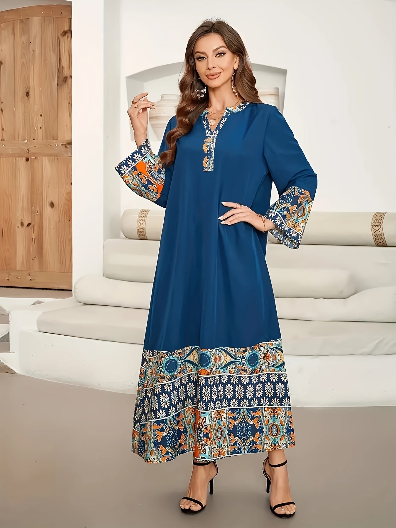 Elegant two-tone Muslim Abaya dress with paisley and floral design, blue long sleeves, polyester fabric, asymmetrical hem, and includes hijab. Ideal for all seasons.