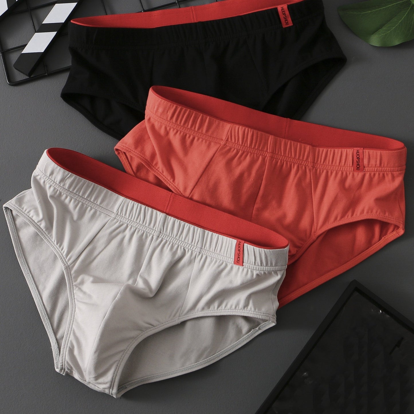 3 men's cotton briefs with breathable and stretchy low-rise design, mixed solid colors, elastic waistband, and comfort fit, suitable for casual everyday wear.