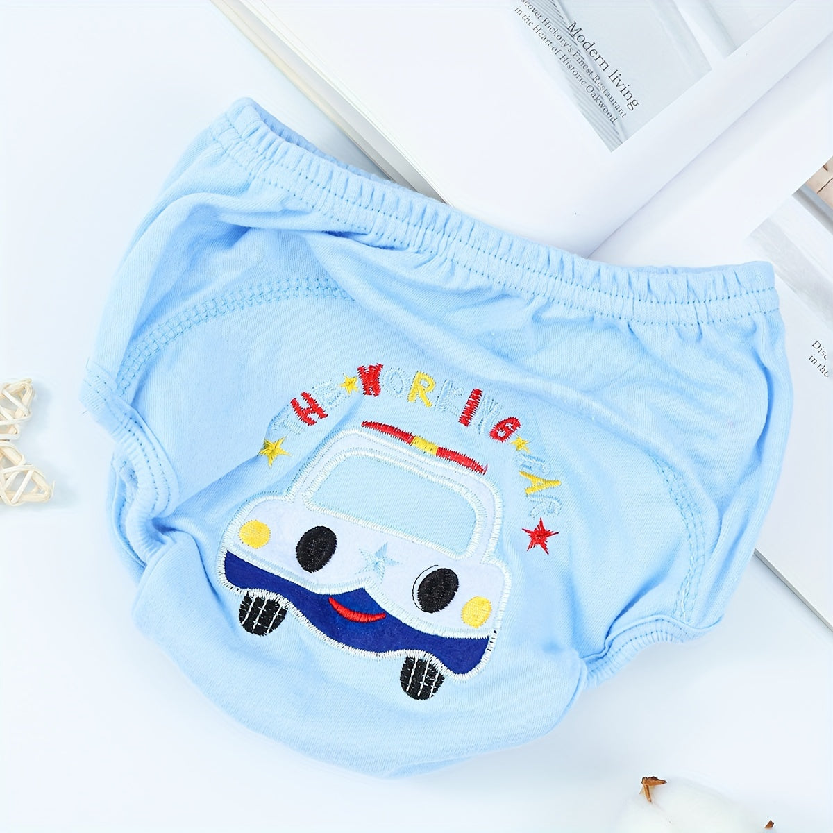 Training pants for toddlers with a fun cartoon pattern - made from 100% cotton for softness and breathability. These washable and reusable pants are highly absorbent and feature a leak-proof design, perfect for potty training essentials.