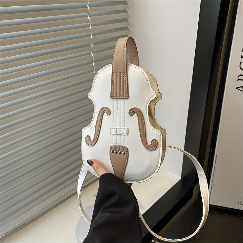 Stylish black/white violin-shaped crossbody bag with adjustable strap, perfect for casual use.