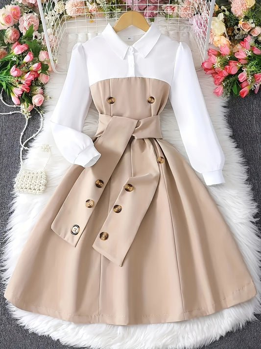 Stylish girls' black and white color block dress with belt and button details, perfect for school or casual wear. A-line silhouette made from a machine washable polyester blend. Suitable