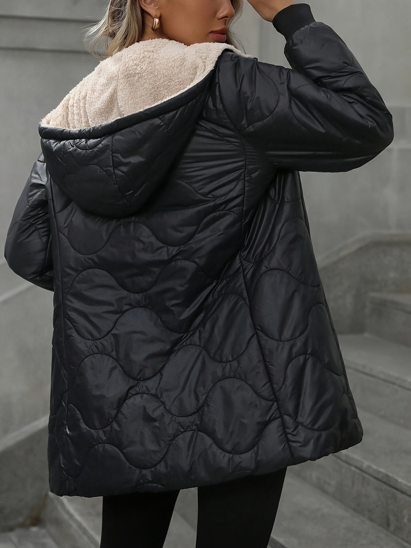 Women's lightweight black winter jacket with faux fur trim, long sleeves, zippered pockets.