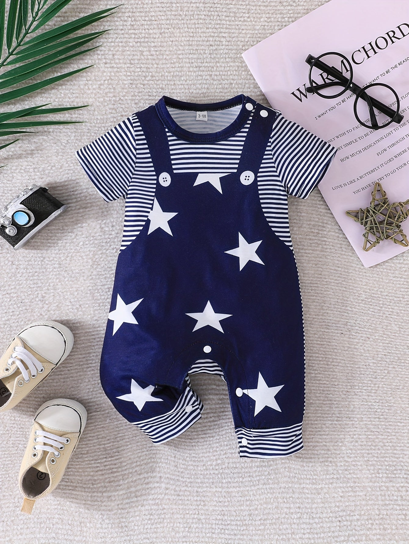 Baby's faux two-piece cartoon star print bodysuit, casual short sleeve romper for outdoor wear.