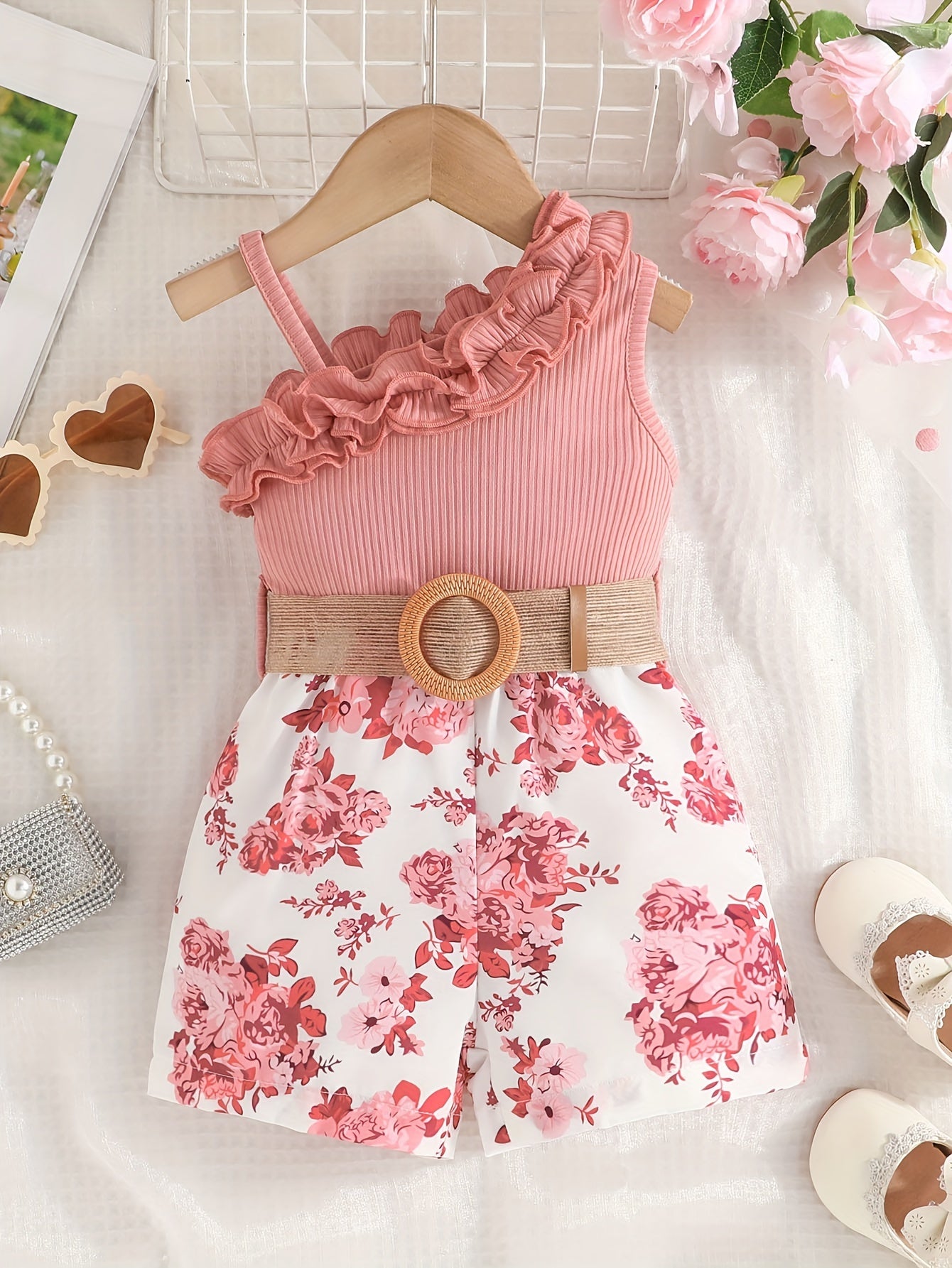 Infant girl's one-shoulder romper with belt in flower pattern for summer outings.