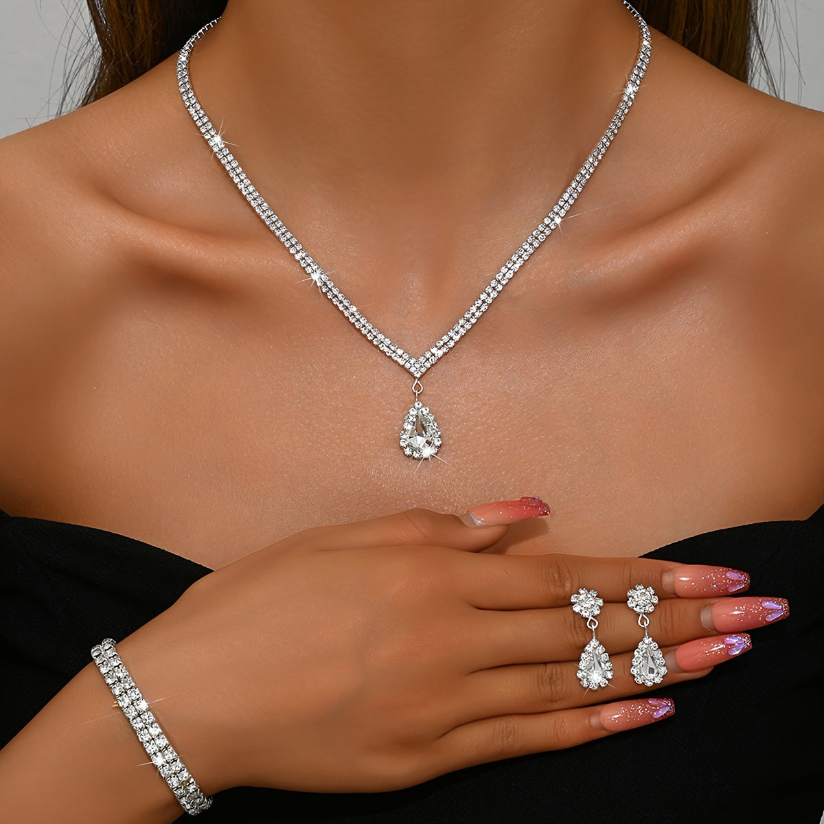 This exquisite collection features luxurious women's jewelry adorned with shimmering water diamonds, including a stunning necklace, elegant earrings, and a versatile stretch bracelet. Perfect for adding a touch of glamour to any party or dance.