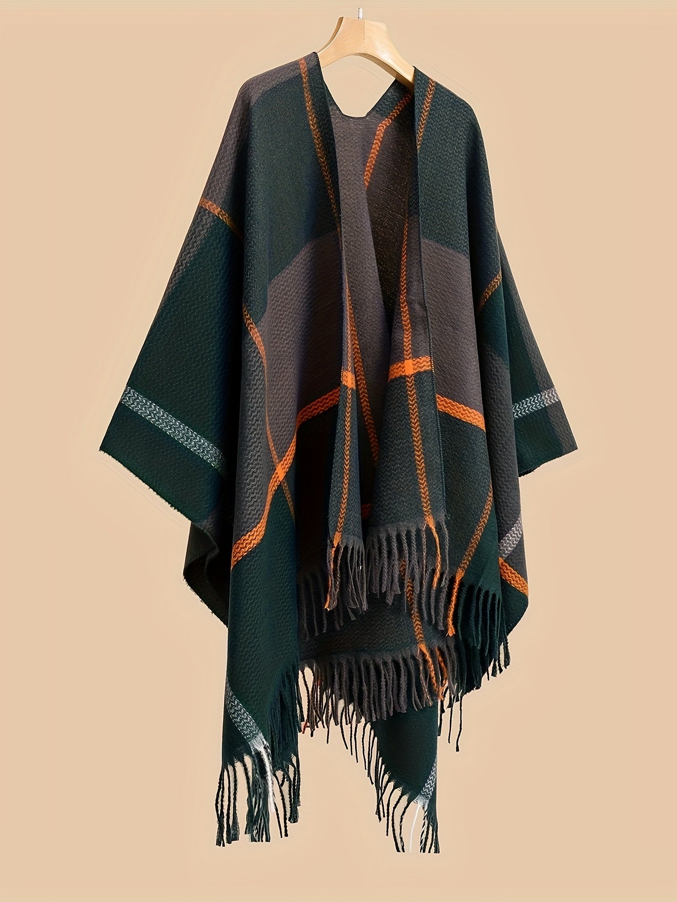 Stylish plus size shawl cardigan with tassels for fall/winter parties features v-neck, asymmetrical hem, and geometric pattern.