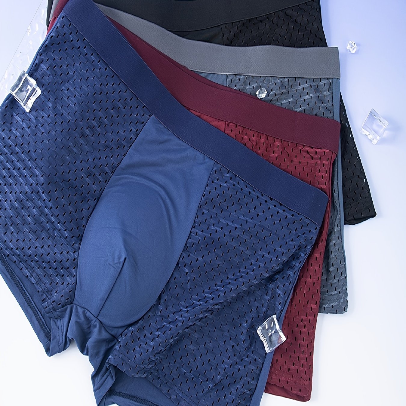 10 assorted men's mesh boxer briefs in navy, dark blue, charcoal, & burgundy with elastic waistband & metal fasteners.