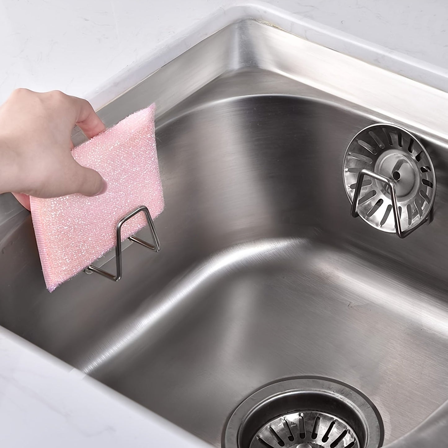 Modern stainless steel sponge holder that can be mounted on the wall in your kitchen sink. Features open storage, waterproof and rust resistant design, and can be easily installed without drilling.