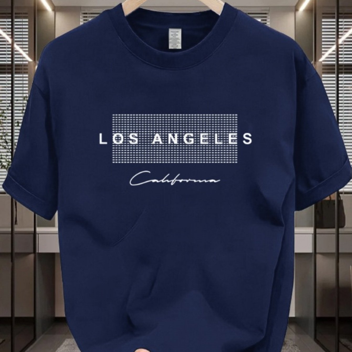 Men's casual cotton T-shirt with crew neck and short sleeves. Made from 100% cotton knit fabric, providing all-season comfort. Features a solid color and a Los Angeles California graphic