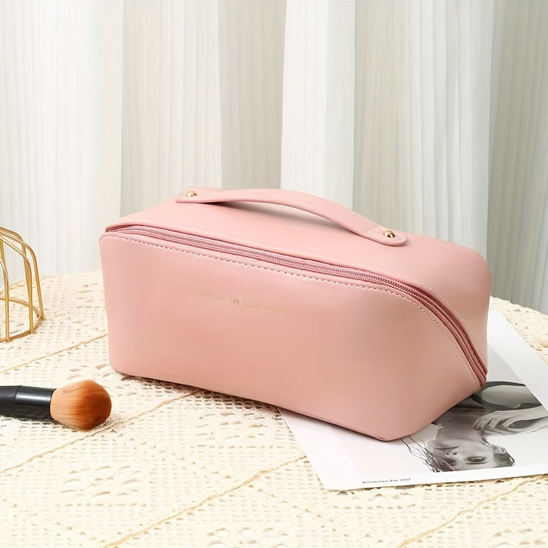 Large travel makeup bag with waterproof, portable design and divider for organizing makeup.