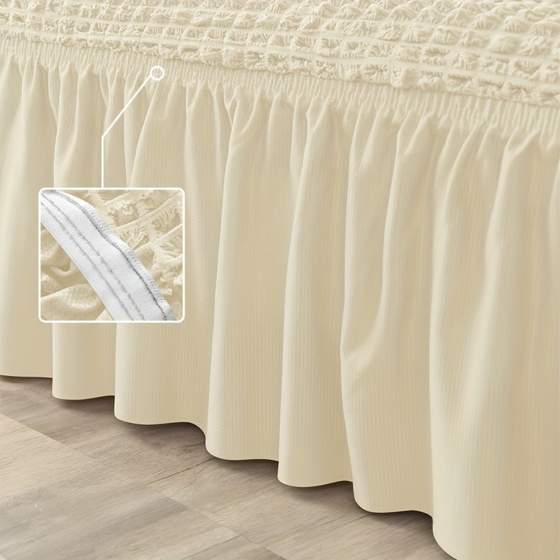 Non-slip elastic sofa cover with skirt for home decor.