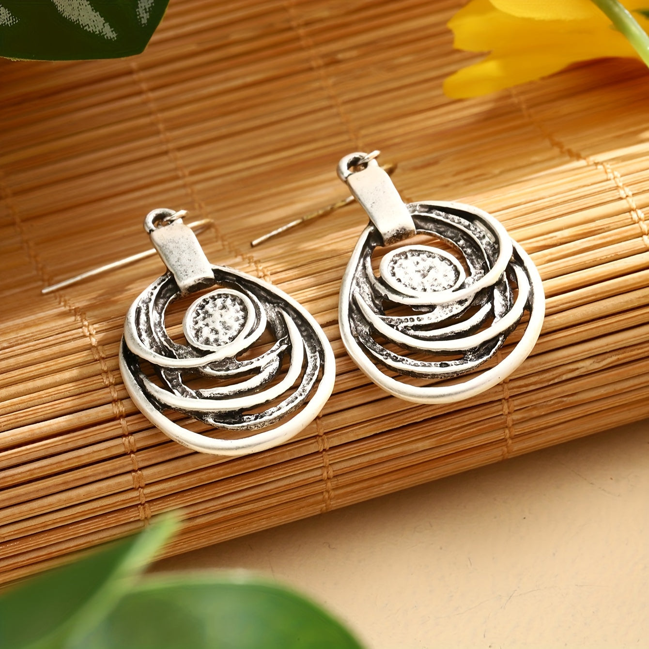 This set includes a pair of earrings and two necklaces made of zinc alloy in an ancient silvery color. The necklaces feature a multi-layer circular mosaic design with a retro bohemian style and a hollow center. This leisure jewelry set is perfect as a