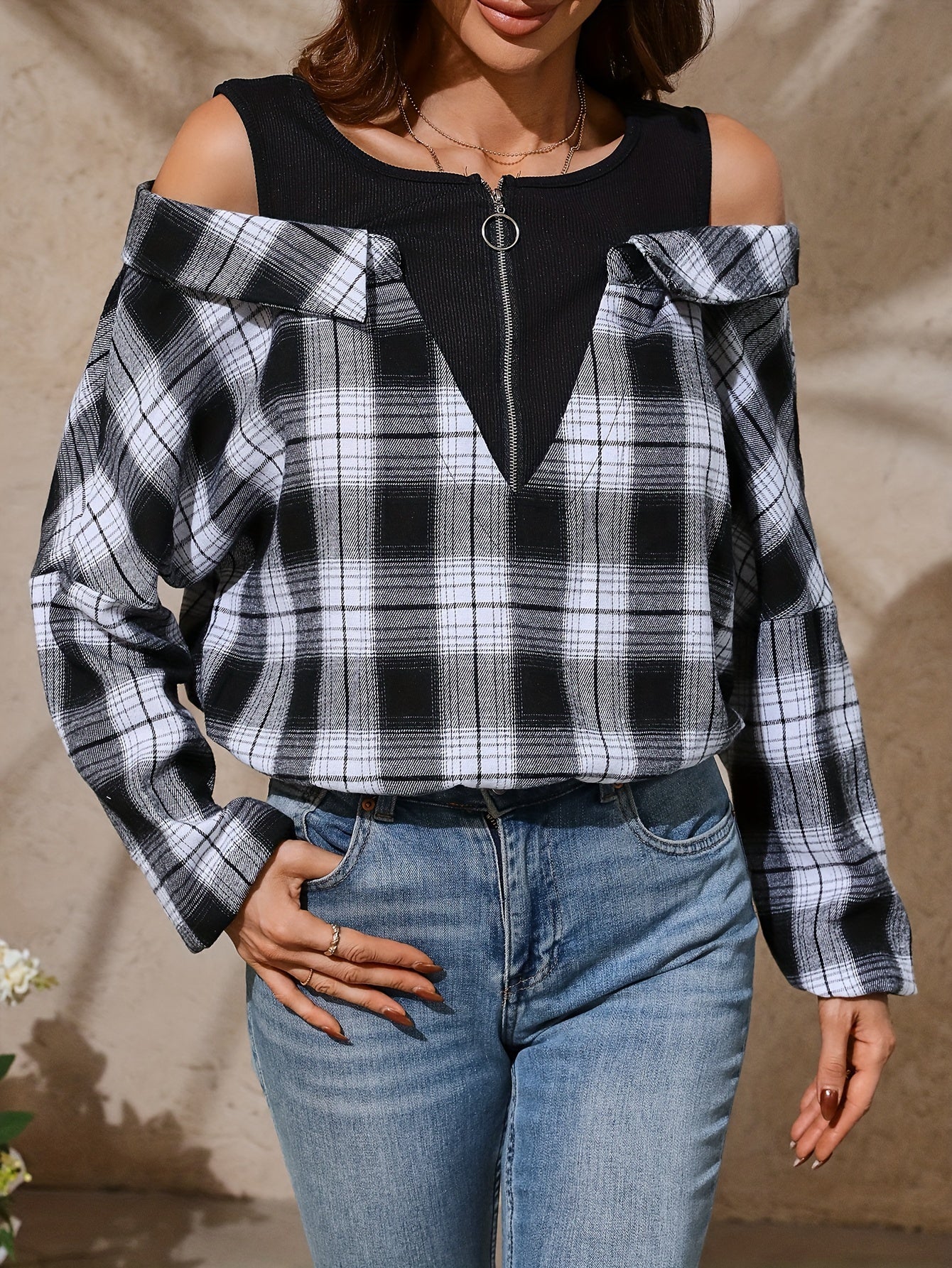 Cold shoulder plaid print blouse with long sleeves and quarter zip, suitable for spring and fall.