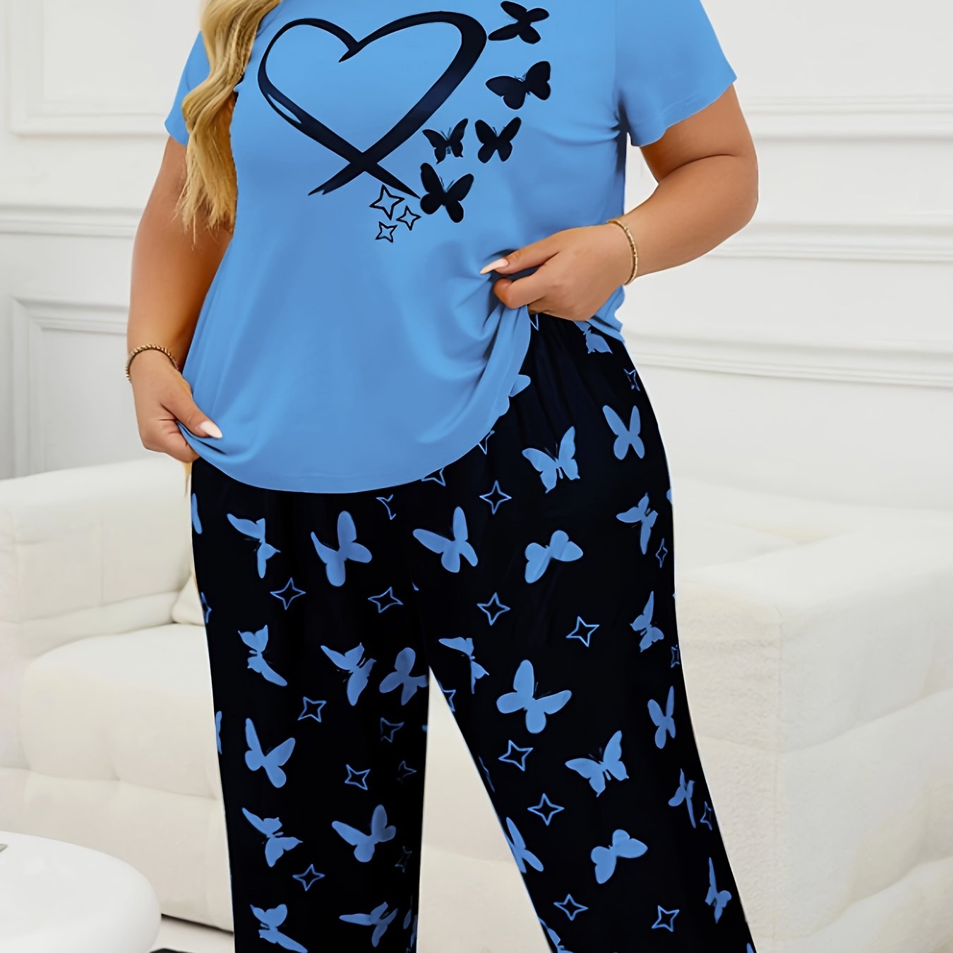 Women's casual butterfly print short sleeve t-shirt and capri pants pajama set made from polyester knit fabric with slight stretch for all-season comfort. 95% polyester, 5% elastane.