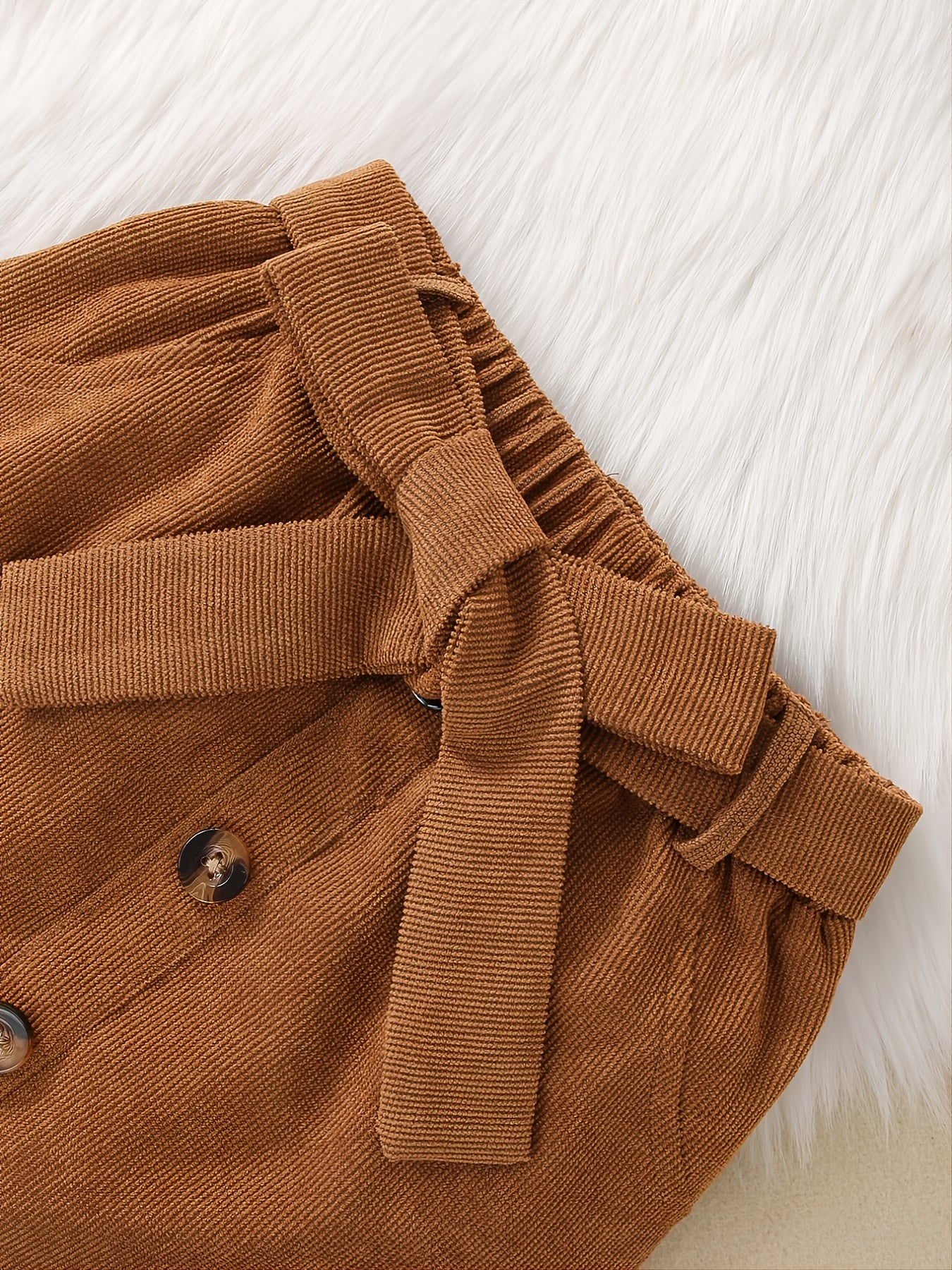 Black ribbed long sleeve top paired with a yellow and brown half skirt set for young girls, by JOPGEEY.