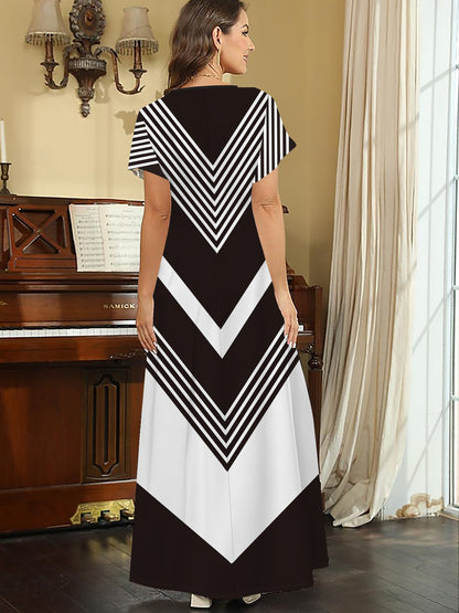 Casual plus size dress with geometric print, V-neck, side slit. Made of stretchy polyester blend, machine washable.