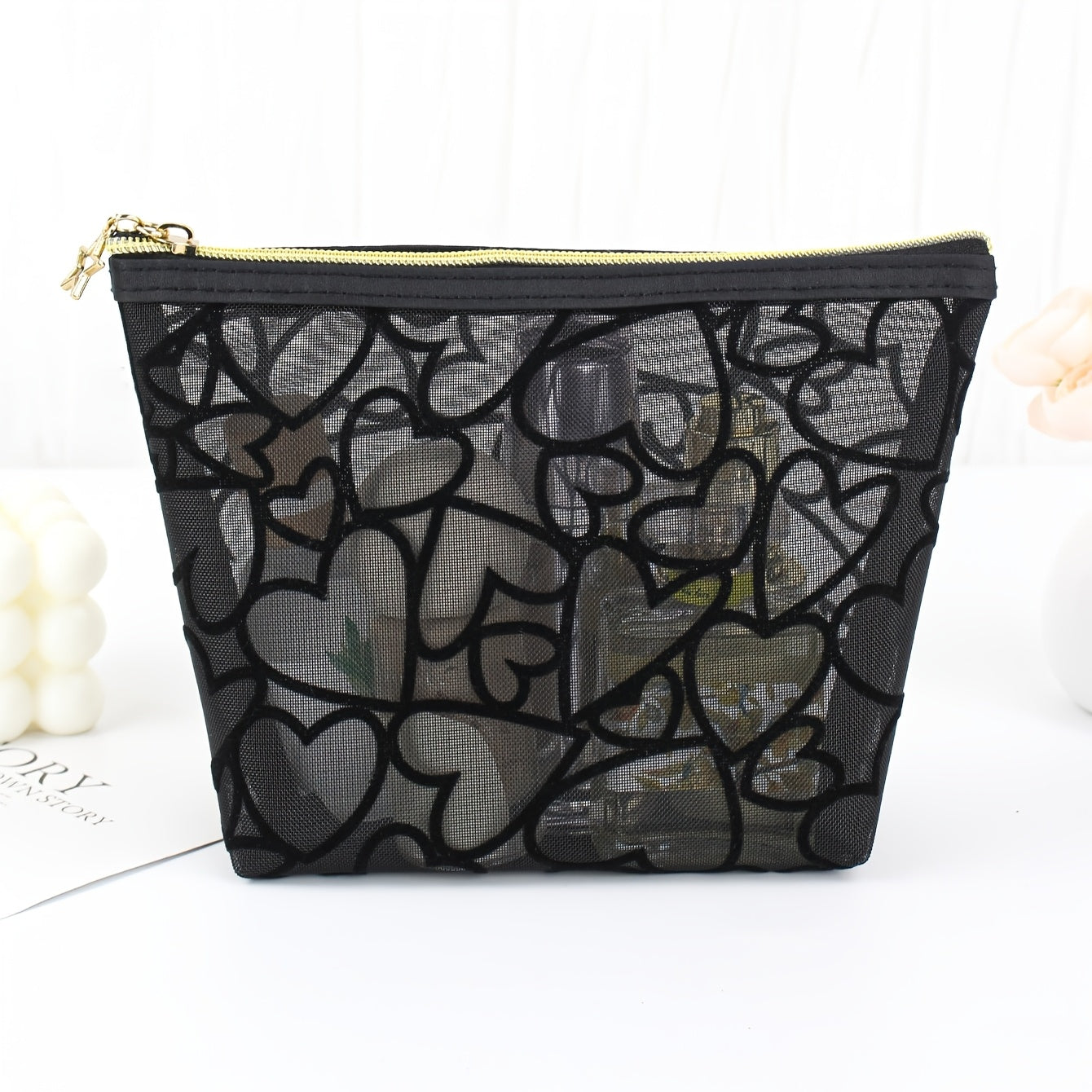 Black waterproof mesh makeup bag with a large capacity, zipper closure, and portable design for travel and toiletries.