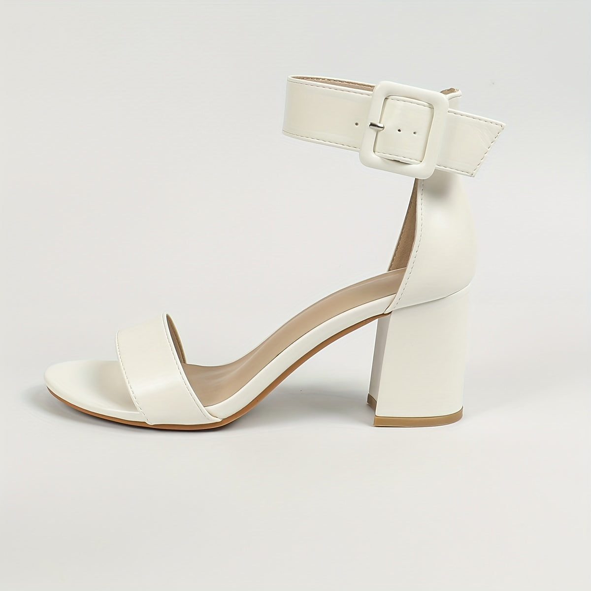 Stylish white block heel sandals with ankle strap and open toe, versatile and comfortable for any occasion.