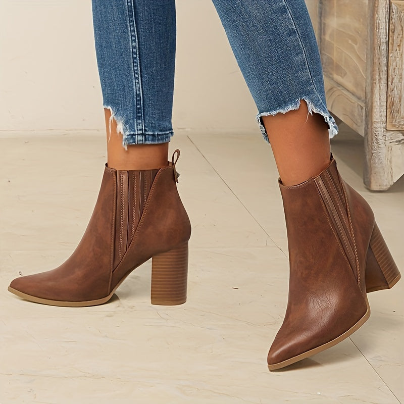 Trendy slip-on ankle boots in solid colors with chunky heels and a pointed toe.