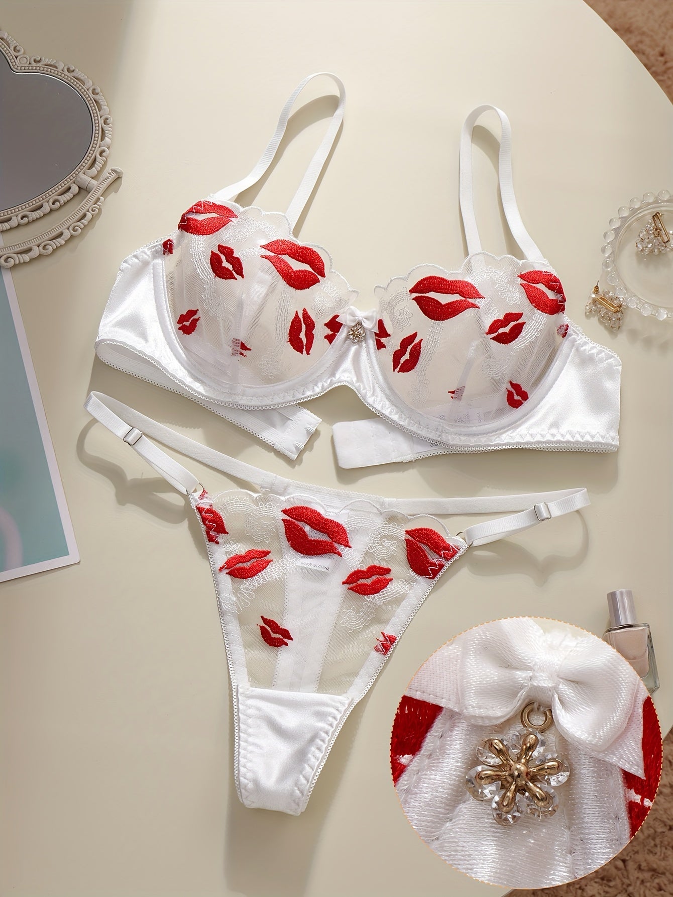 Floral embroidered lingerie set with sexy lips pattern, made of polyester knit fabric. Includes a geometric-patterned bralette and thong, no padding.