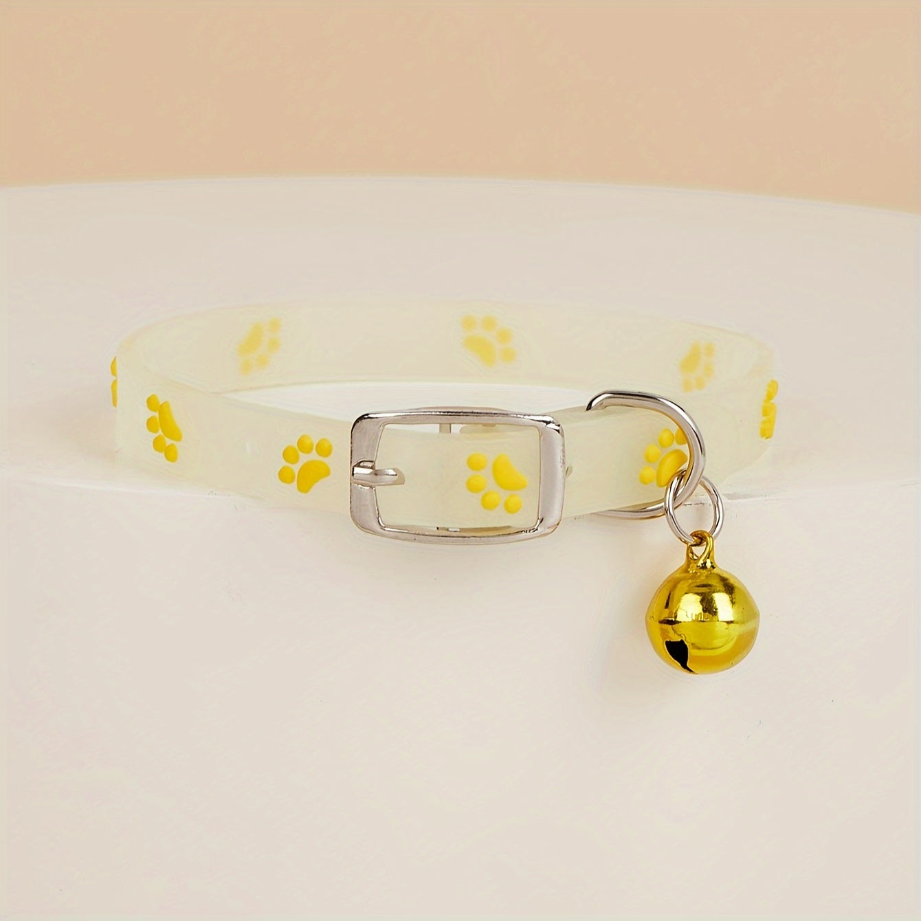 Adjustable glow-in-the-dark cat collar with colorful paw print for easy spotting at night.