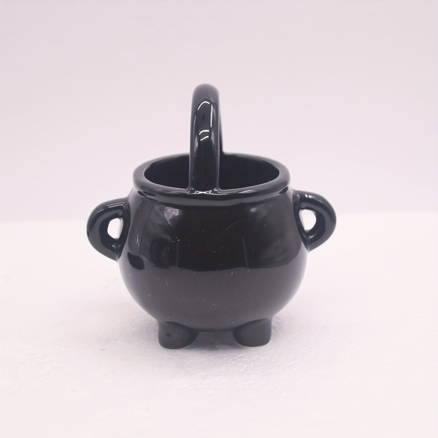 Black ceramic cauldron oil burner with iron holder, glossy finish, aroma diffuser and wax melt warmer, tealight candle holder for home decor. No incense needed.