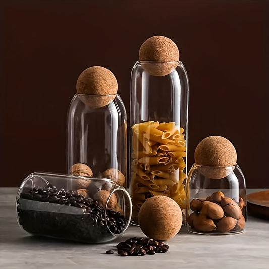 Airtight glass kitchen jars with cork lids for coffee, tea, and spices.