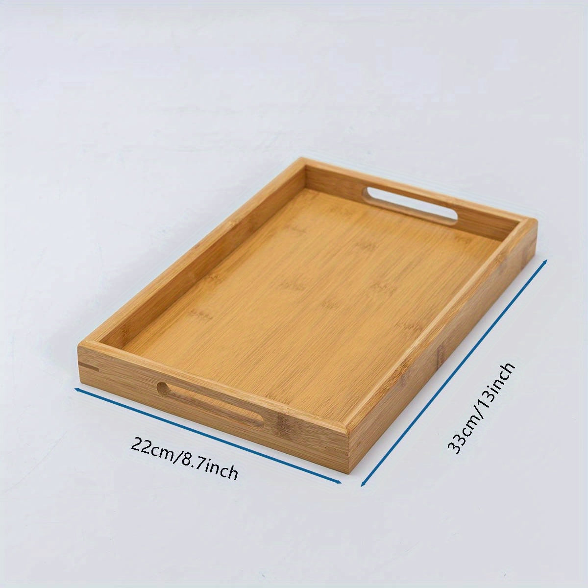 Bamboo serving tray with handles for eating, working, and storing in various locations.