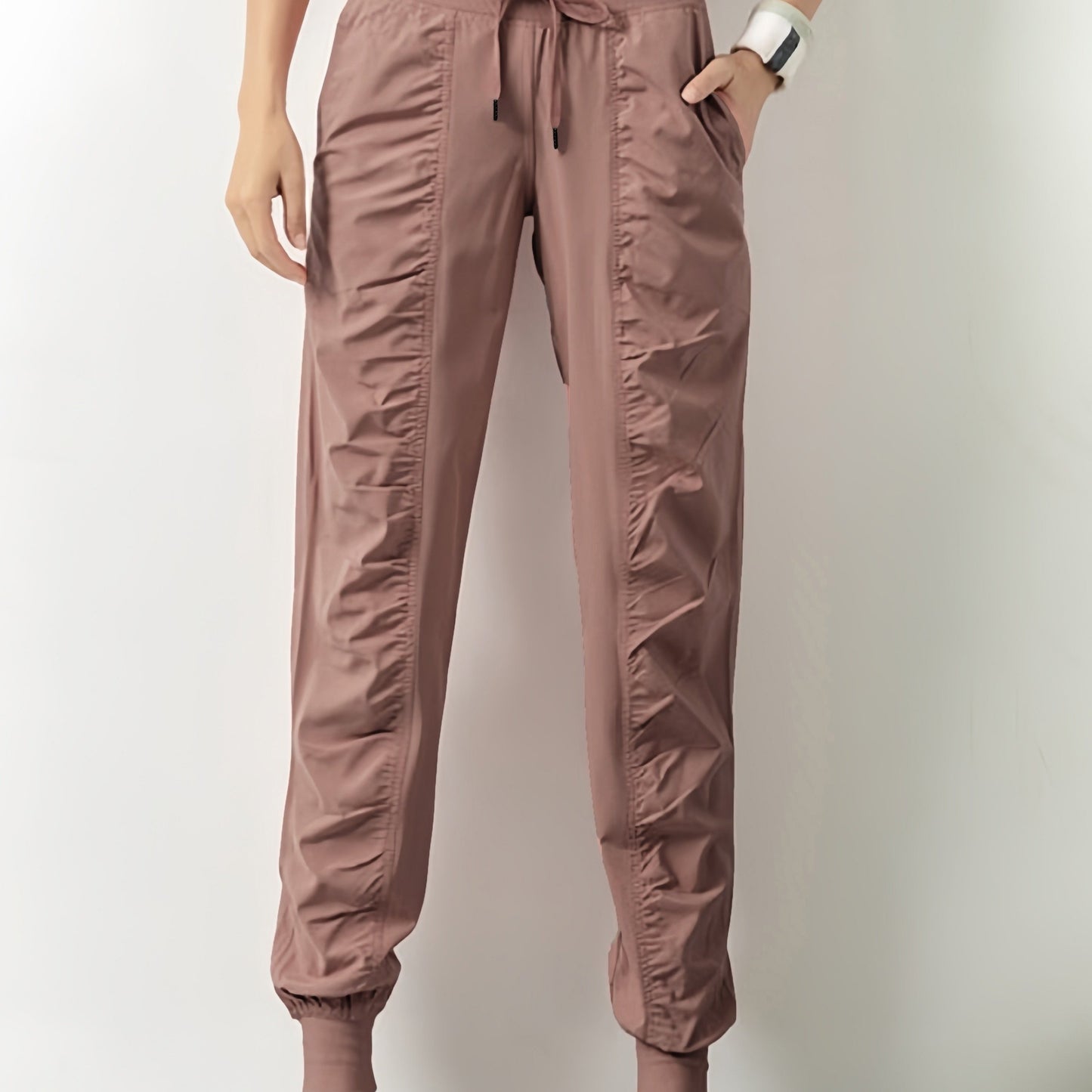 Women's solid color sports pants with drawstring waist, quick drying material, and side pockets for casual comfort.