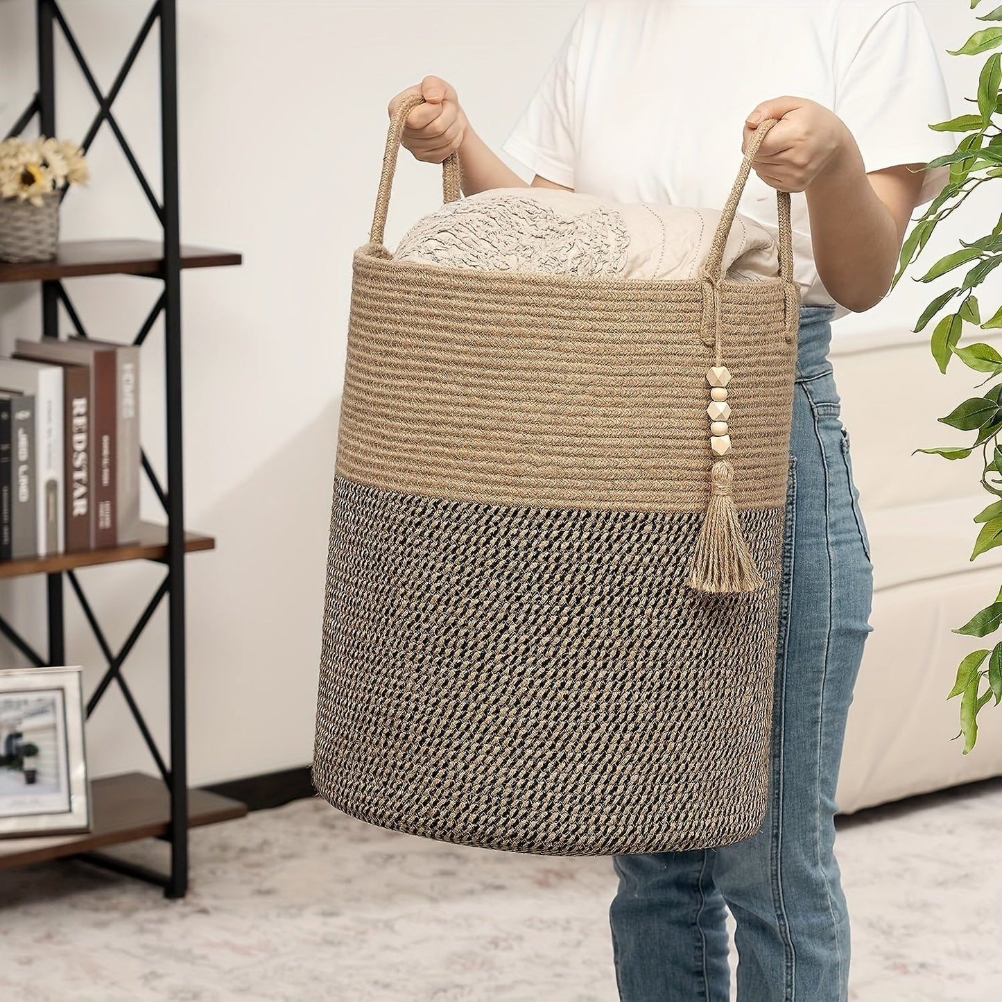 This tall laundry basket measures 40.64cm X 50.8cm and features a woven design with a convenient handle. It can be used as a blanket organizer in the living room, a storage basket for dog toys, or a decorative jute laundry hamper for clothes, pillows