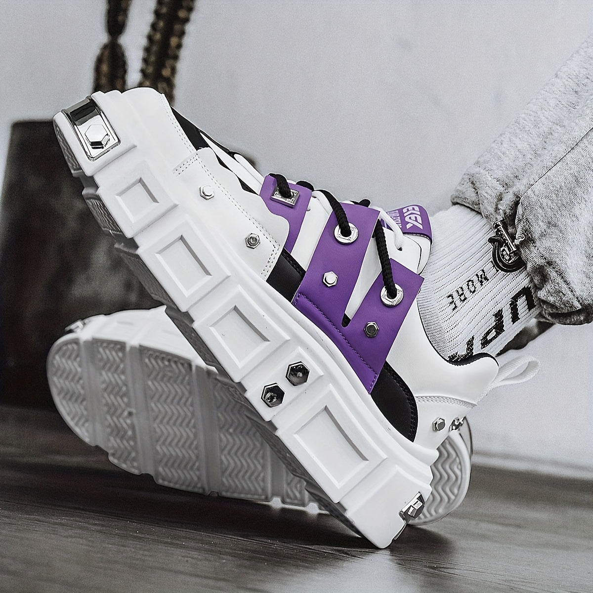 Chunky, punk-inspired sneakers with metal stud accents. Streetwear fashion statement in white, thick-soled trainers. Ideal for skateboarding, parties, and everyday wear. Unisex.