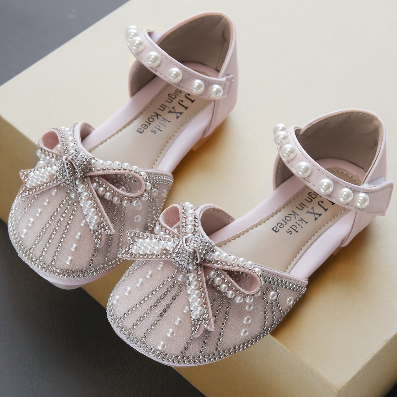 Sparkly bowknot flats with adjustable strap, durable TPR sole, comfortable for daily wear for girls aged 14 and under.