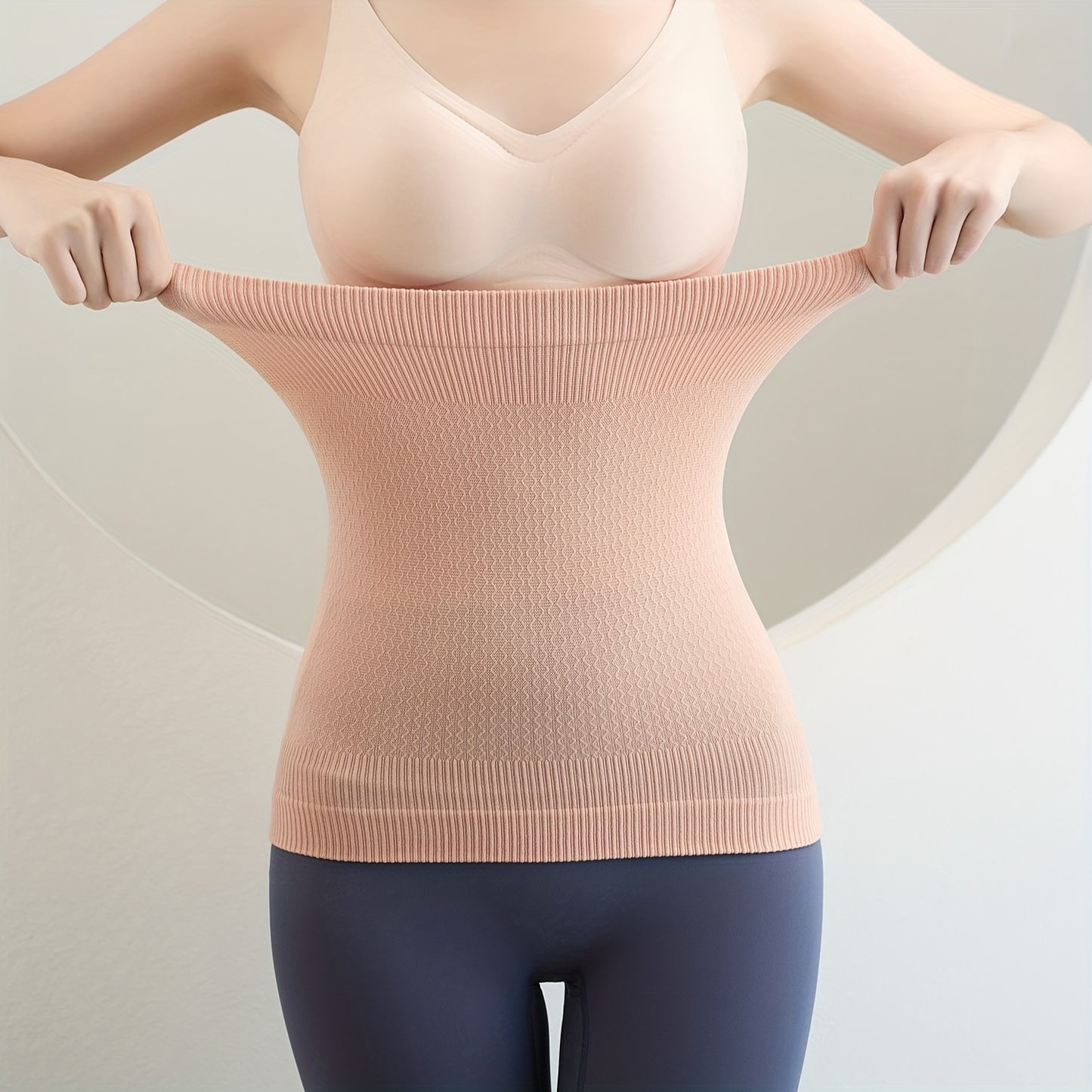 Seamless waist trainer for women, shapes and controls tummy.