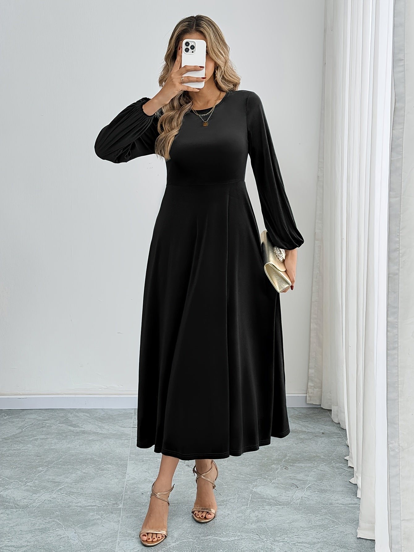 Black velvet A-line dress with flared sleeves, crew neck, and long sleeve made of polyester knit for all-season wear. Ideal for adult women's fashion as elegant attire.