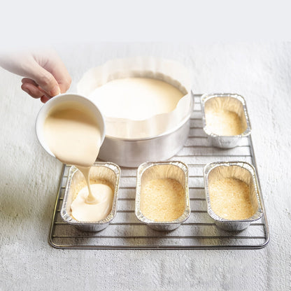 Set of 50 mini loaf pans perfect for baking bread, made of disposable aluminum foil material. Each pan weighs 453.59g and measures 15.24cm X 8.89cm X 5.08cm.