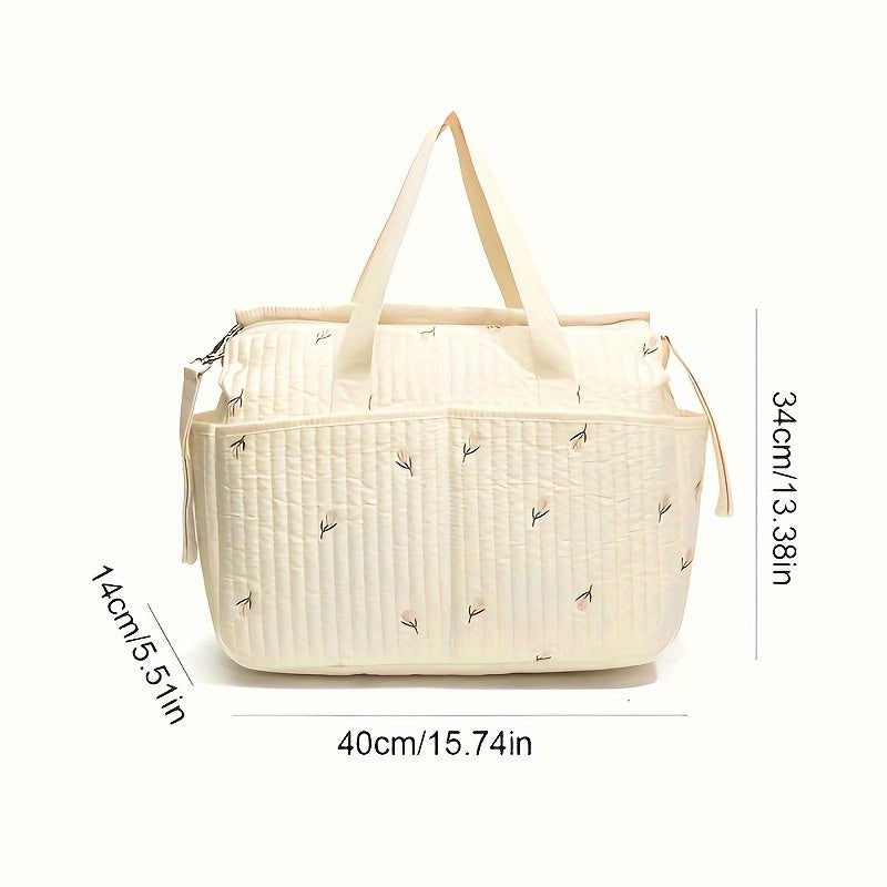 Large-capacity parent bag with a stylish print, designed for travel and diaper storage, featuring a trolley attachment for added convenience.