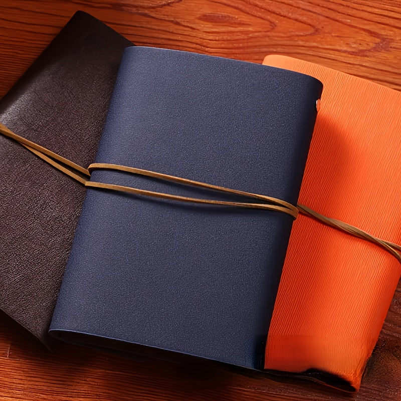 Vintage spiral-bound faux leather notebook with leaf-embossed design and strap closure, available in black, orange, and blue, perfect for students and travelers.