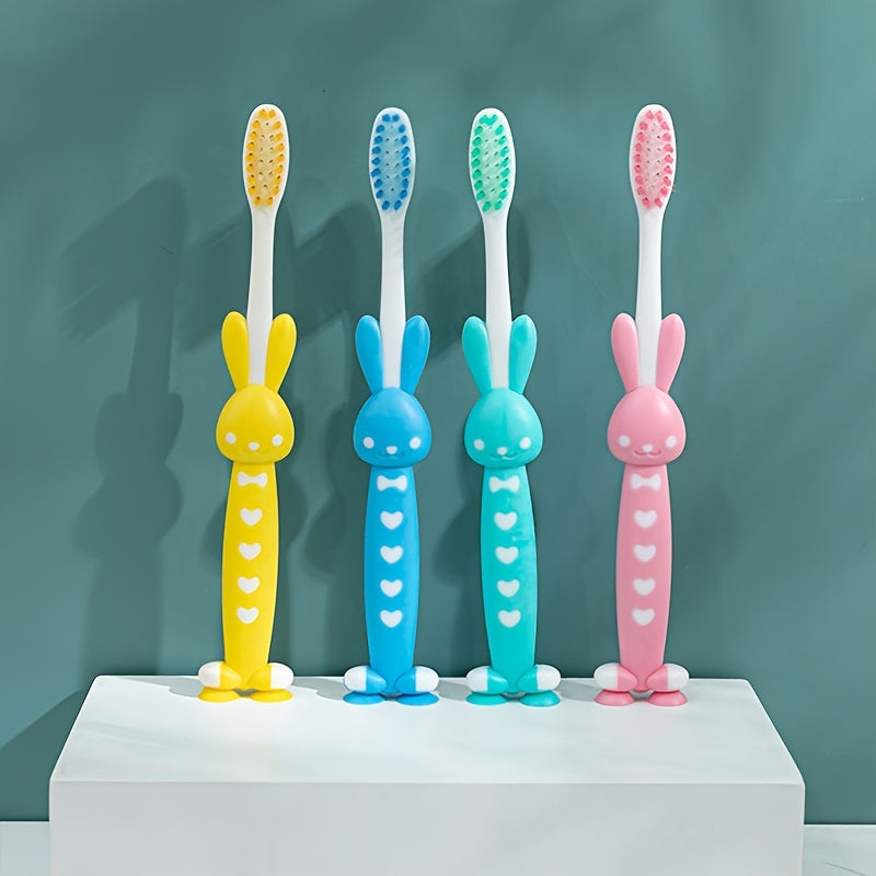 4 soft-bristled toothbrushes with charcoal and cute animal designs for teeth care.